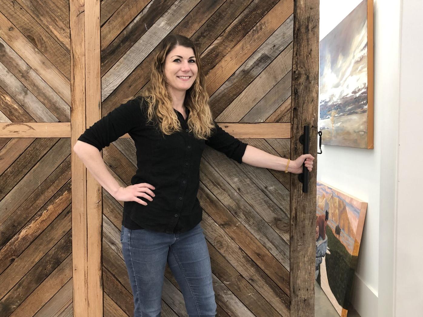 Nicole Lampl, visual arts director at Elm Street Cultural Arts village, opens the door to the education room where workshops and classes will be held. Art will also be displayed. Ethan Johnson