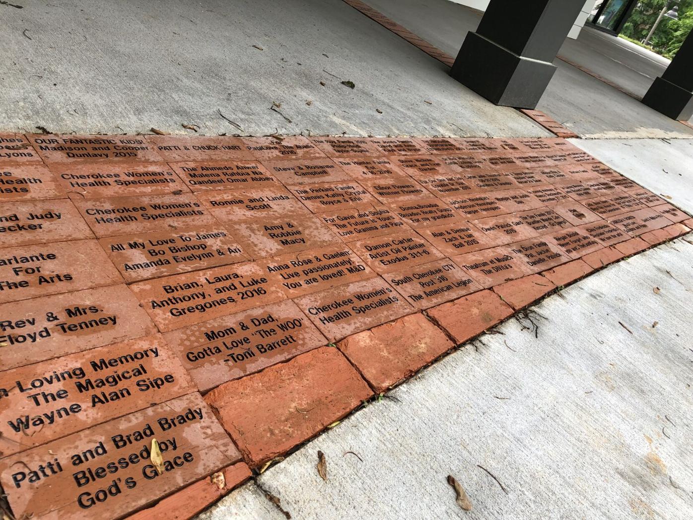 An area of bricks at the front showcases names of people who helped [sic] raised funds for the creation of the arts center. Ethan Johnson